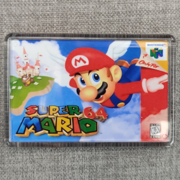 A circular image of a Super Mario 64 Nintendo video game fridge magnets against a fabric background