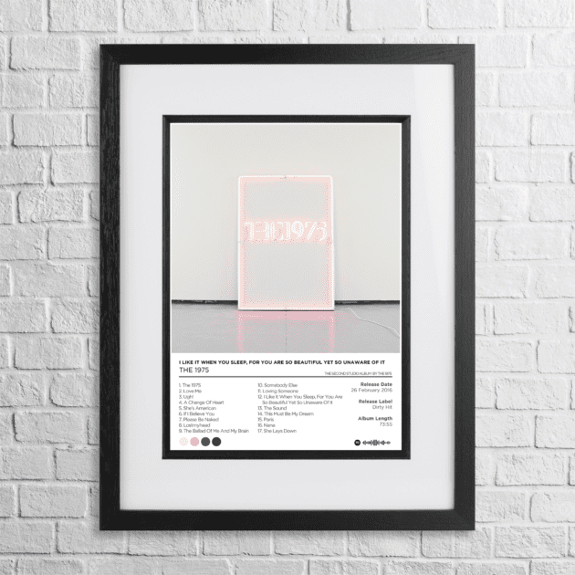 A4 custom design poster of 1975 - I Like It When You Sleep in a black, dual-aspect frame on a white brick background