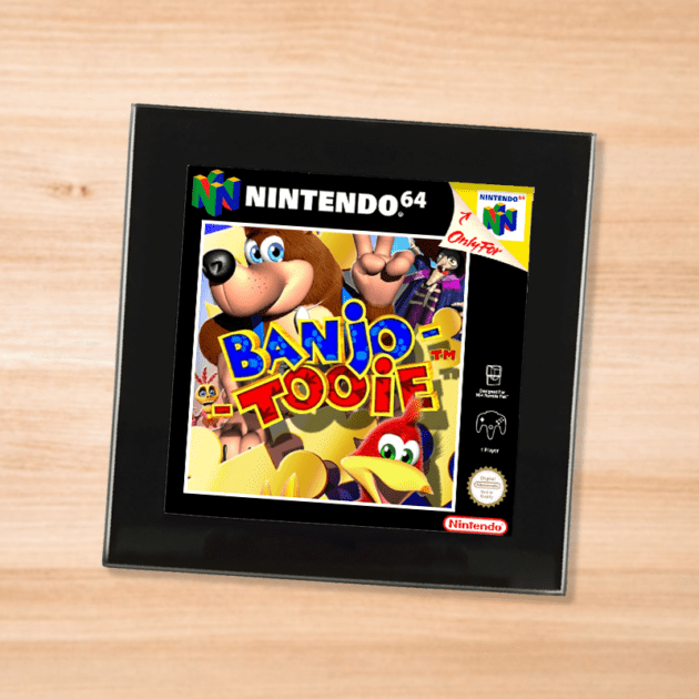 Black glass Banjo Tooie coaster on a wood table