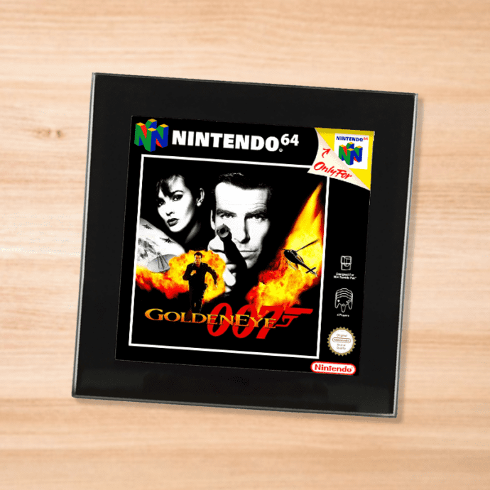 Black glass Goldeneye 007 coaster on a wood table