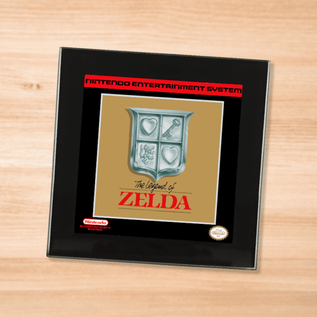 Black glass Legend of Zelda coaster on a wood table