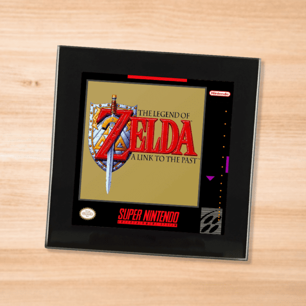 Black glass Legend of Zelda A Link to the Past coaster on a wood table