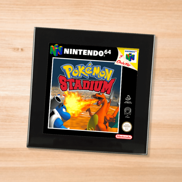 Black glass Pokemon Stadium coaster on a wood table