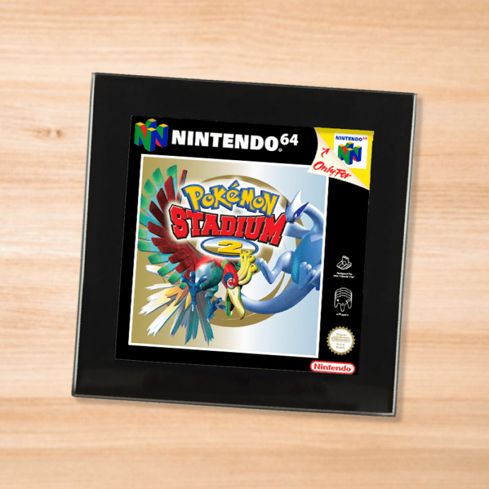 Black glass Pokemon Stadium 2 coaster on a wood table
