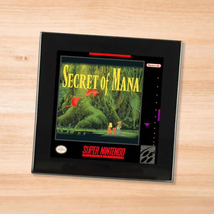 Black glass Secret of Mana coaster on a wood table