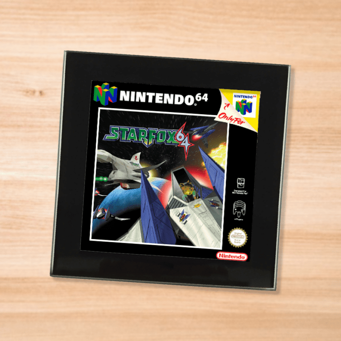 Black glass Star Fox 64 coaster on a wood table