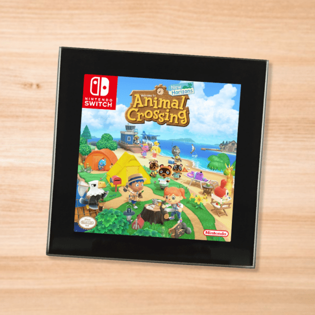 Black glass Animal Crossing New Horizons coaster on a wood table