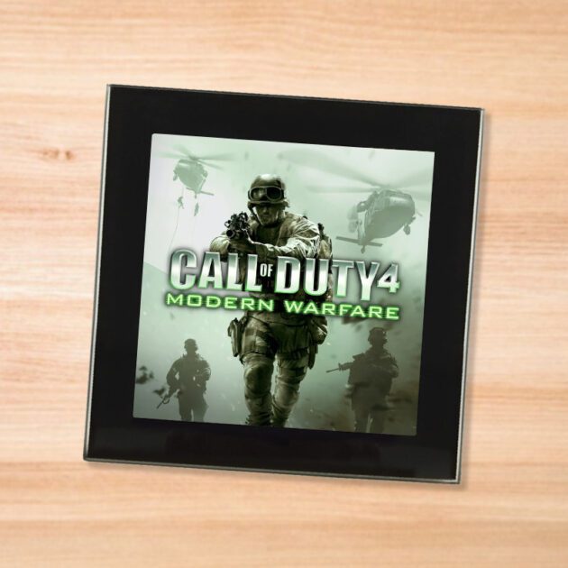 Black glass Call of Duty Modern Warfare coaster on a wood table