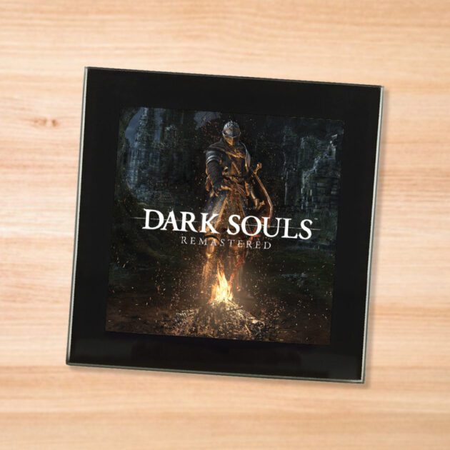 Black glass Dark Souls coaster on a wood table