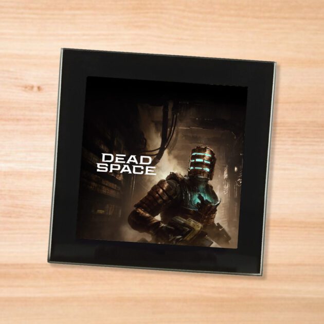 Black glass Dead Space Remake coaster on a wood table