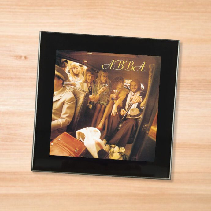 Black glass ABBA - Abba coaster on a wood table