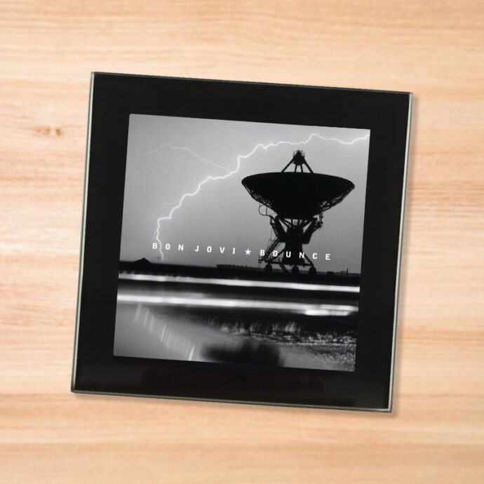 Black glass Bon Jovi - Bounce coaster on a wood table