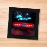 Black glass Midnight - Days of Thunder coaster on a wood table