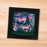 Black glass Midnight - Horror Show coaster on a wood table