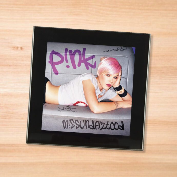 Black glass Pink - Missundaztood coaster on a wood table