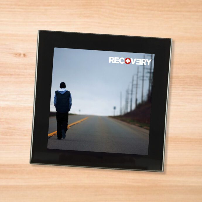 Black glass Eminem - Recovery coaster on a wood table