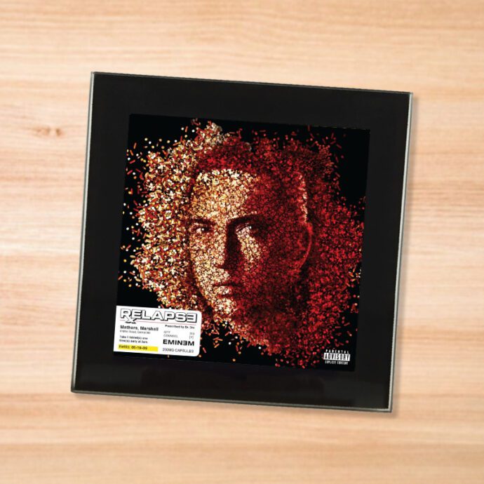 Black glass Eminem - Relapse coaster on a wood table