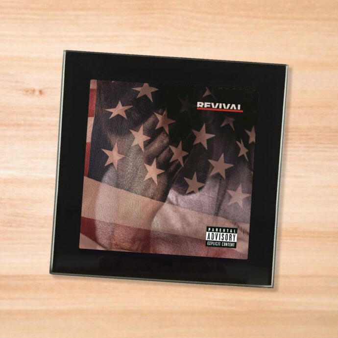 Black glass Eminem - Revival coaster on a wood table