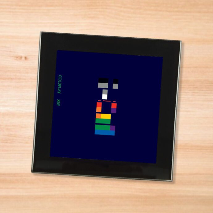 Black glass Coldplay - X&Y coaster on a wood table