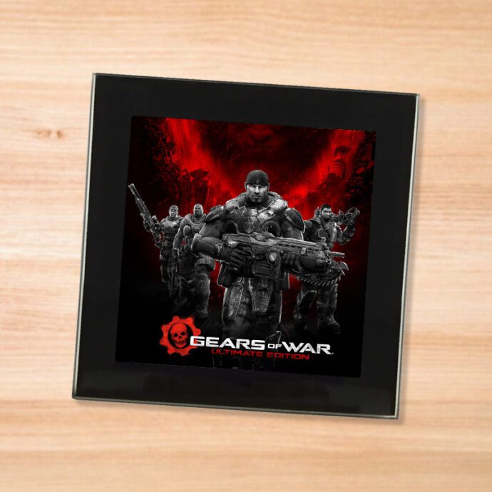 Black glass Gears of War coaster on a wood table