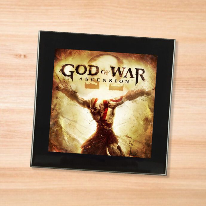 Black glass God of War Ascension coaster on a wood table