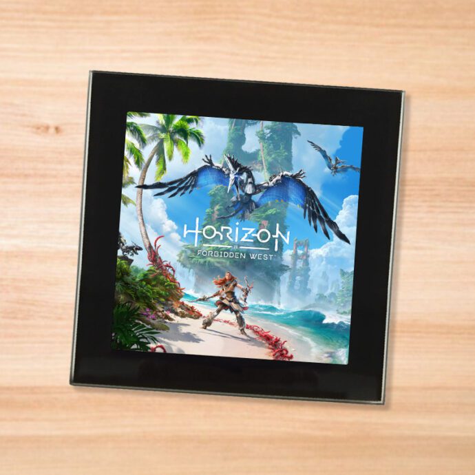 Black glass Horizon Forbidden West coaster on a wood table