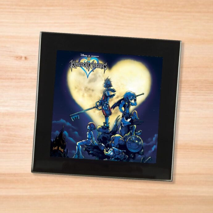 Black glass Kingdom Hearts coaster on a wood table