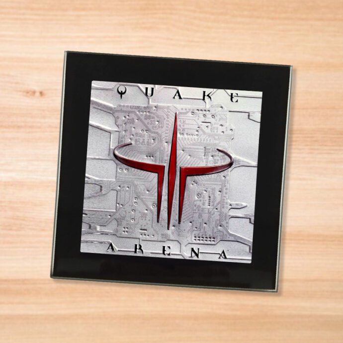 Black glass Quake 3 coaster on a wood table