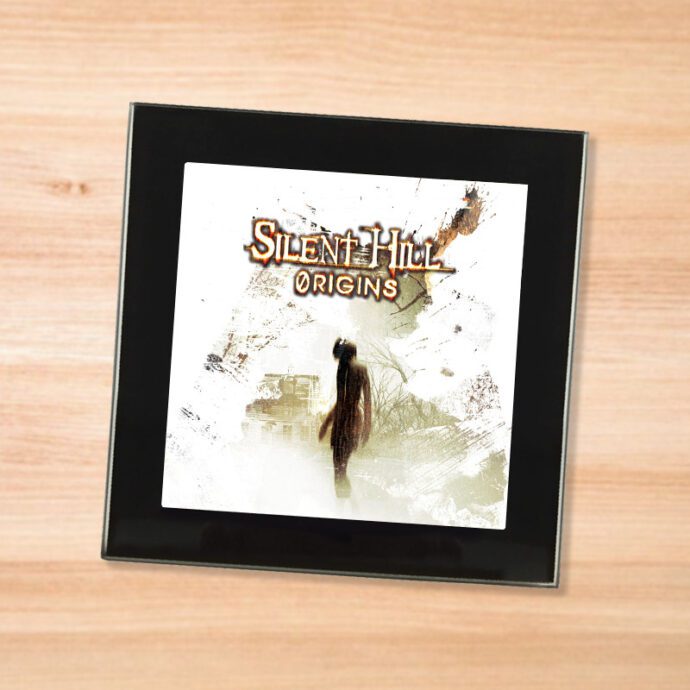 Black glass Silent Hill Origins coaster on a wood table