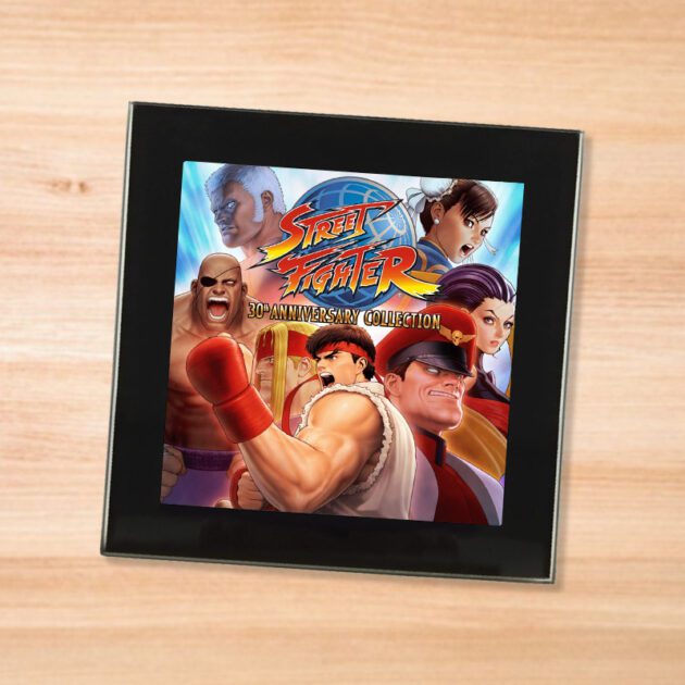 Black glass Street Fighter Anniversary coaster on a wood table