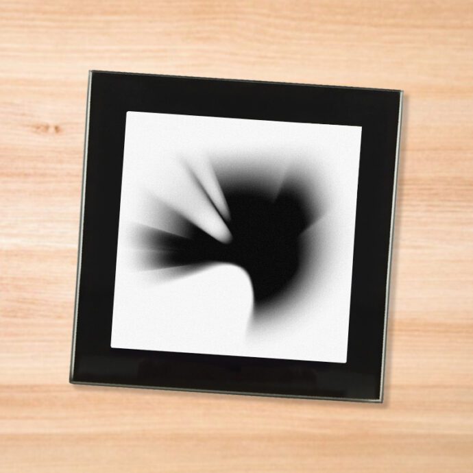 Black glass Linkin Park - Thousand Suns coaster on a wood table