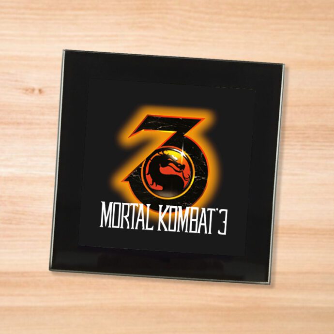 Black glass Mortal Kombat 3 coaster on a wood table