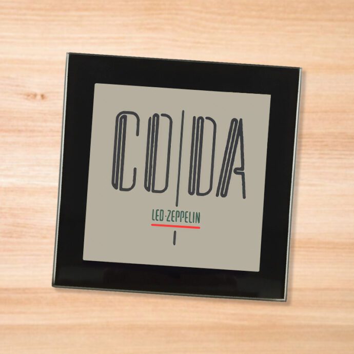 Led Zeppelin Coda black glass coaster on a wood table