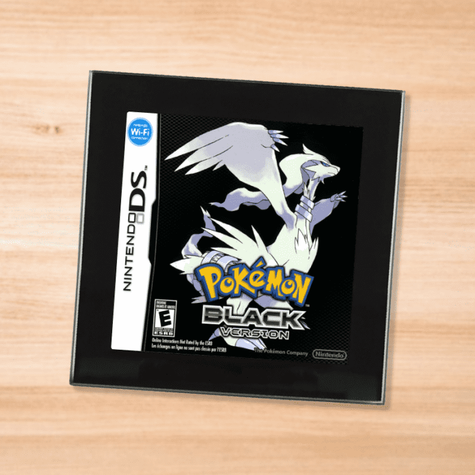 Pokemon Black black glass coaster on a wood table