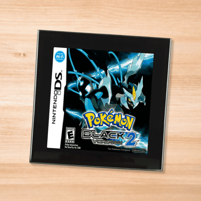 Pokemon Black 2 black glass coaster on a wood table