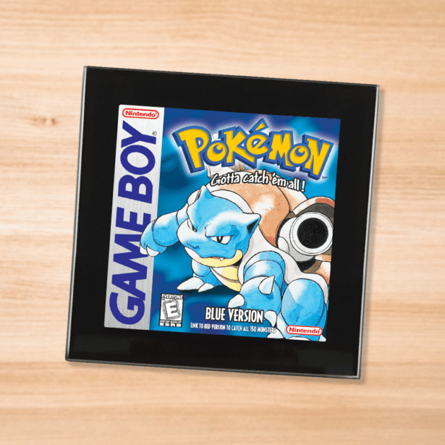 Pokemon Blue black glass coaster on a wood table