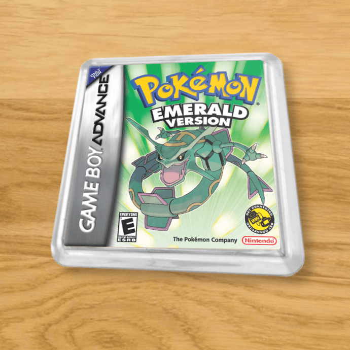 Pokemon Emerald plastic coaster on a wood table