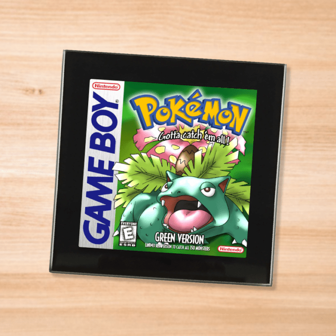Pokemon Green black glass coaster on a wood table