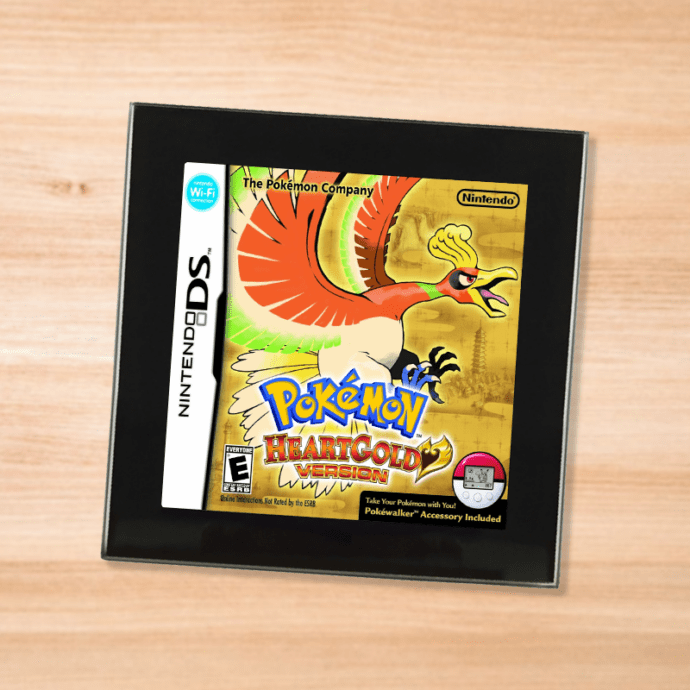 Pokemon Heart Gold black glass coaster on a wood table