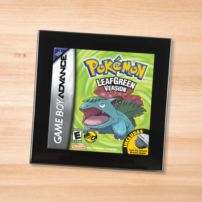 Pokemon Leaf Green black glass coaster on a wood table
