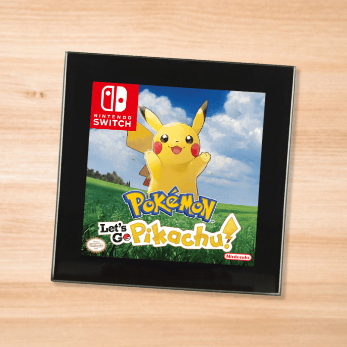 Pokemon Pikachu black glass coaster on a wood table