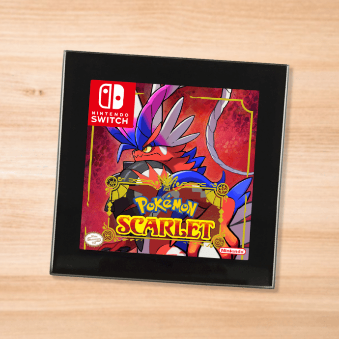 Pokemon Scarlet black glass coaster on a wood table