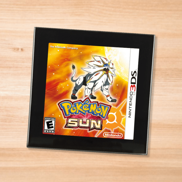 Pokemon Sun black glass coaster on a wood table