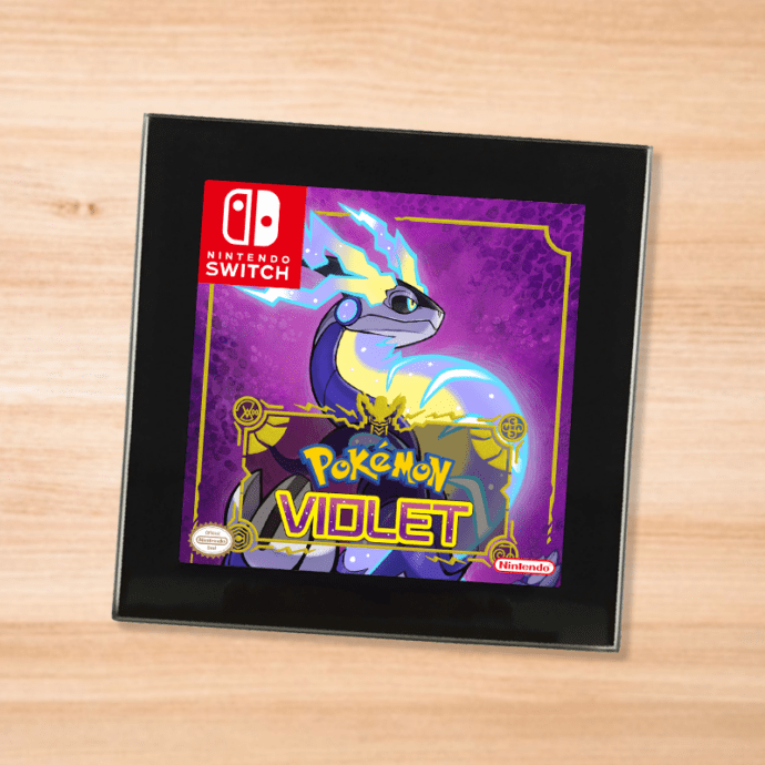Pokemon Violet black glass coaster on a wood table