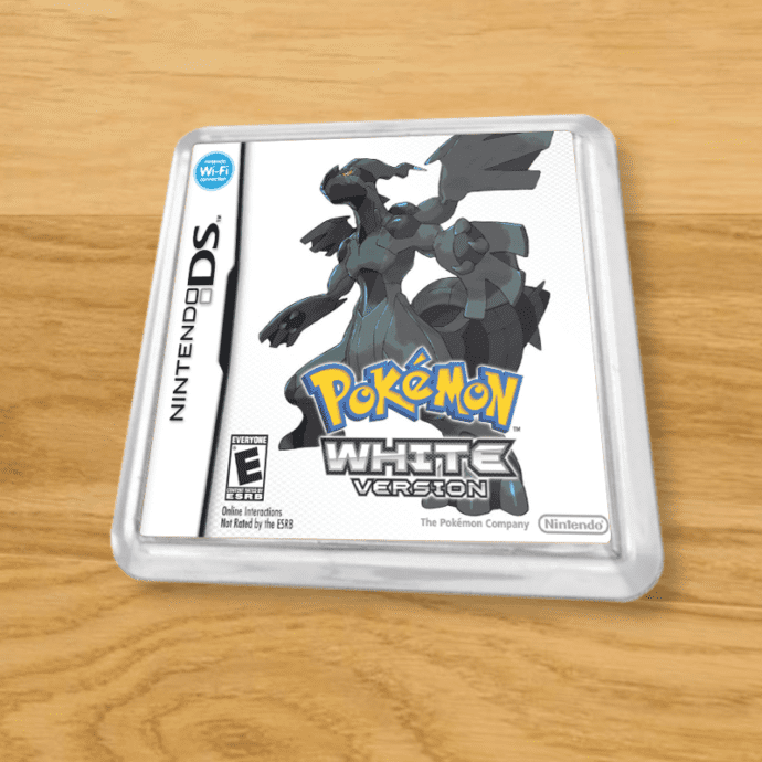 Pokemon White plastic coaster on a wood table