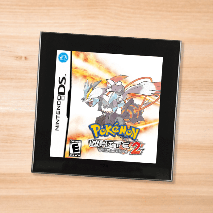 Pokemon White 2 black glass coaster on a wood table