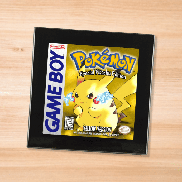 Pokemon Yellow black glass coaster on a wood table