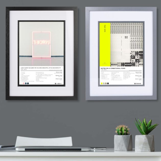 The 1975 album poster prints - 2 framed posters on a dark grey wall